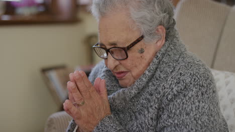 portrait of old mixed race woman praying looking up hopeful retired senior female in retirement home