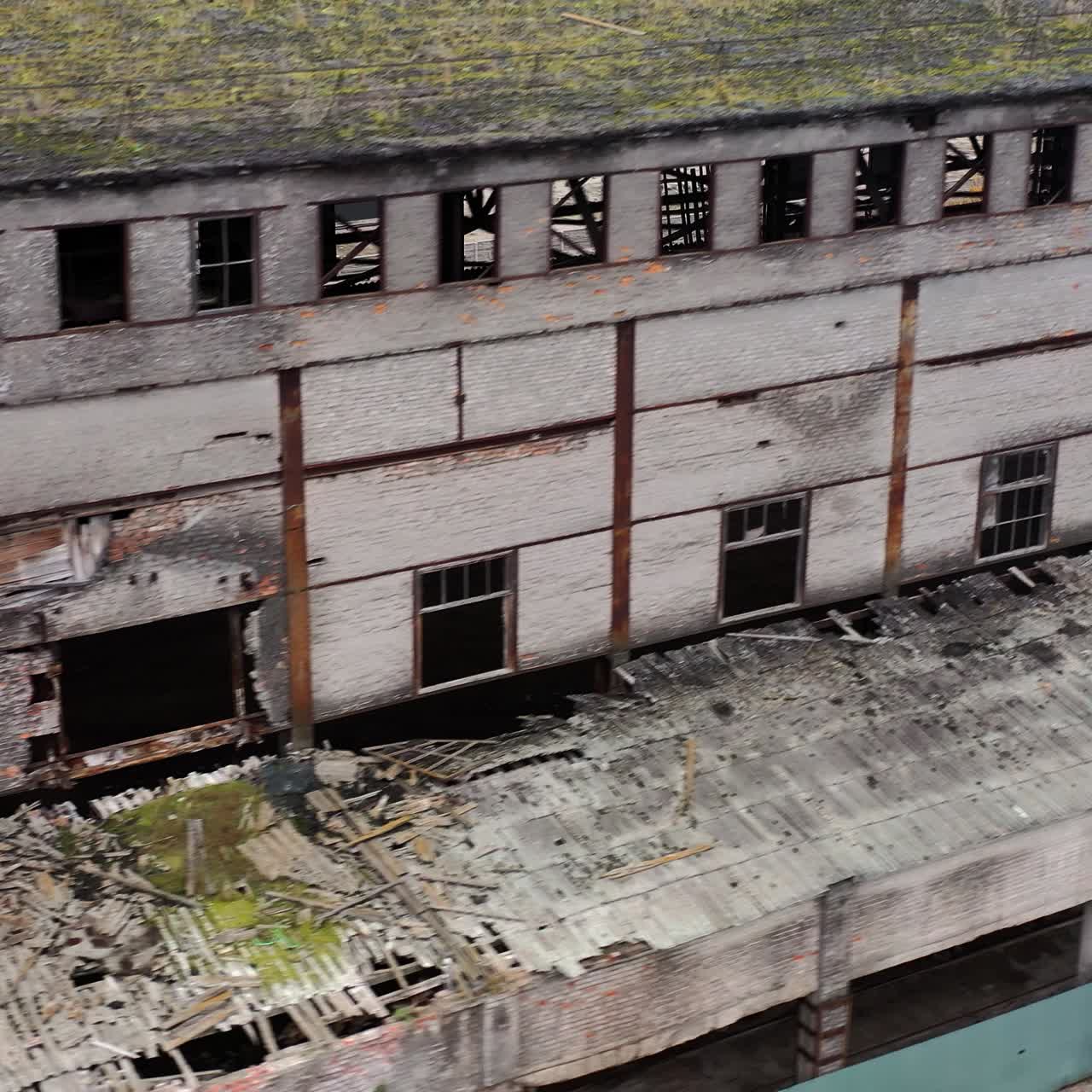 Ruined architecture after military actions. Abandoned building with broken windows and many hole in walls. Damaged building outdoors. Aerial view.