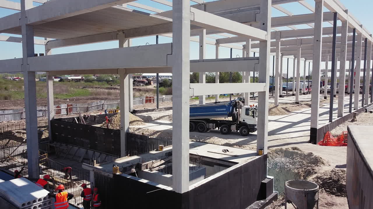 Construction Site with Concrete Beams and Dump Truck