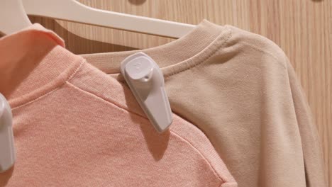 clothes on hangers with anti-theft tags