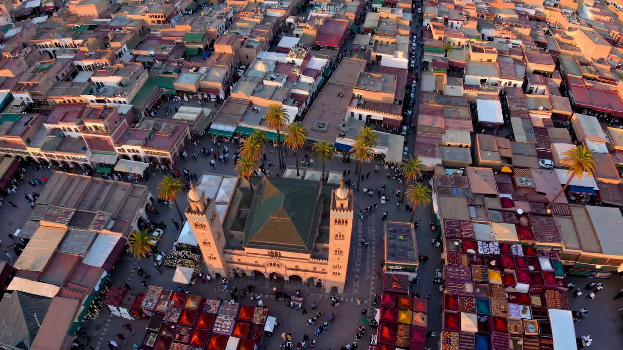 Aerial video view of a bustling cityscape with a central mosque, showcasing vibrant rooftops