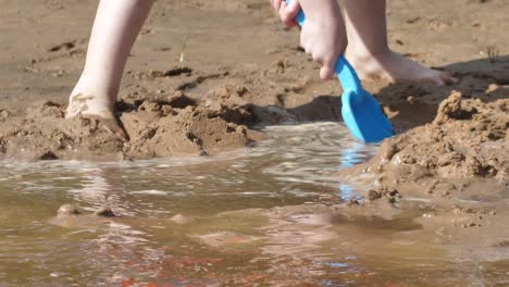 the child was playing with wet sand