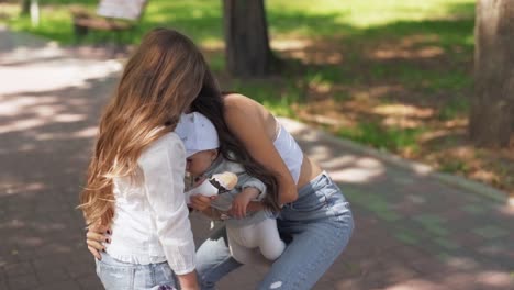 Handheld-medium-shot-of-a-young-girl-eating-ice-cream-in-the-park-then-surprised-by-her-mother-and-baby-brother-with-a-kiss