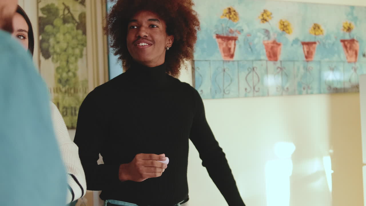 A man talking to another man in an indoor setting