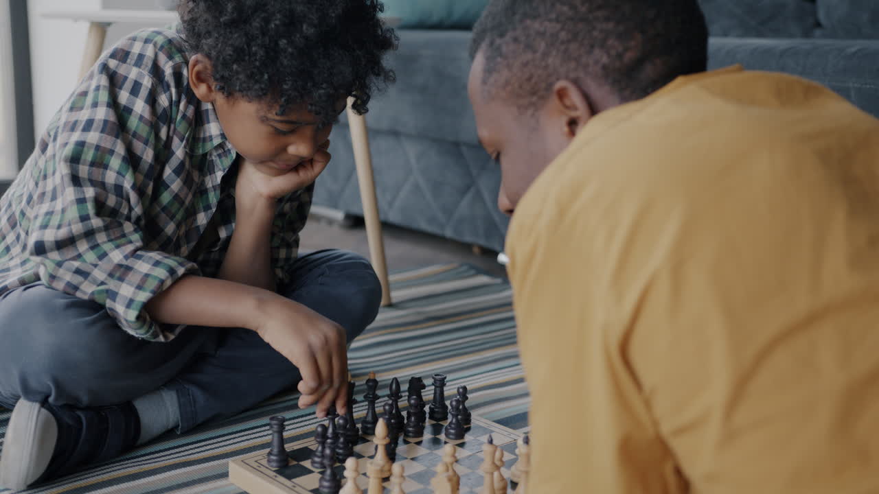 Father and Son Playing Chess at Home
