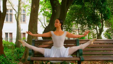 Young-ballerina-practicing-dance-on-the-bench-in-the-park-4k