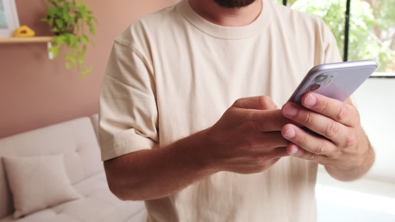 Man Typing and Scrolling on Mobile Phone Screen