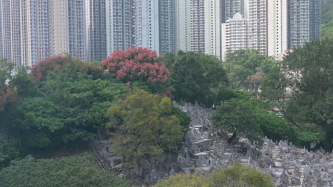 View of a crowded cemetery as residential buildings are seen in the background during the Chung Yeung Festival when people visit deceased relatives&#039; graves in remembrance and respect