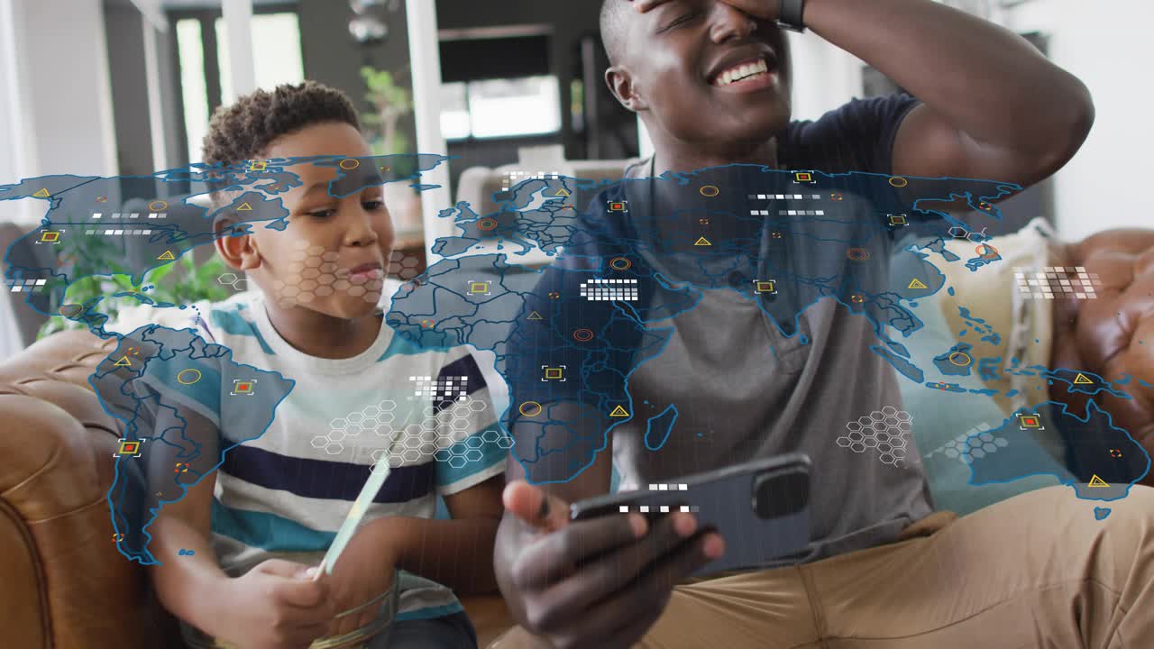 Father pointing phone and son waving Brazil flag while watching sports, map overlay linking flags