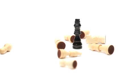 chess pieces fallen around the king