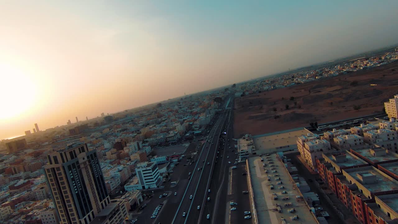FPV Drone's Cinematic Turn Highlights the Busy Roads of Jeddah with a Setting Sun