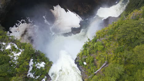 aerial tilt down over helmcken falls water flow, canada