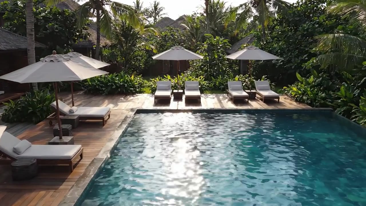 Beautiful Tropical Pool Oasis Featuring Relaxing Loungers and Elegant Umbrellas Surrounded by Lush Greenery in a Luxurious Setting