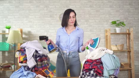 young woman housewife does not know what to choose an iron or steamer for ironing clothes