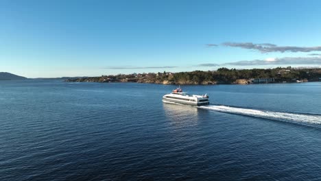 Aerial-following-catamaran-Fjordbris-carrying-passengers-to-Bergen,-Norway