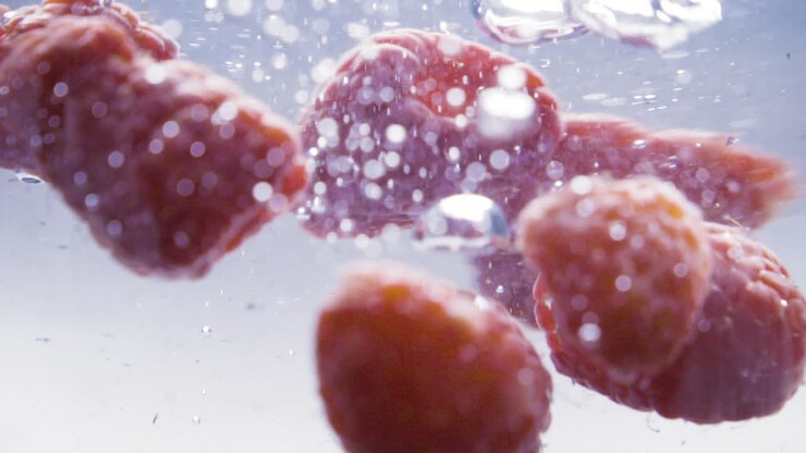Slowmotion of assorted berrys falling on to water