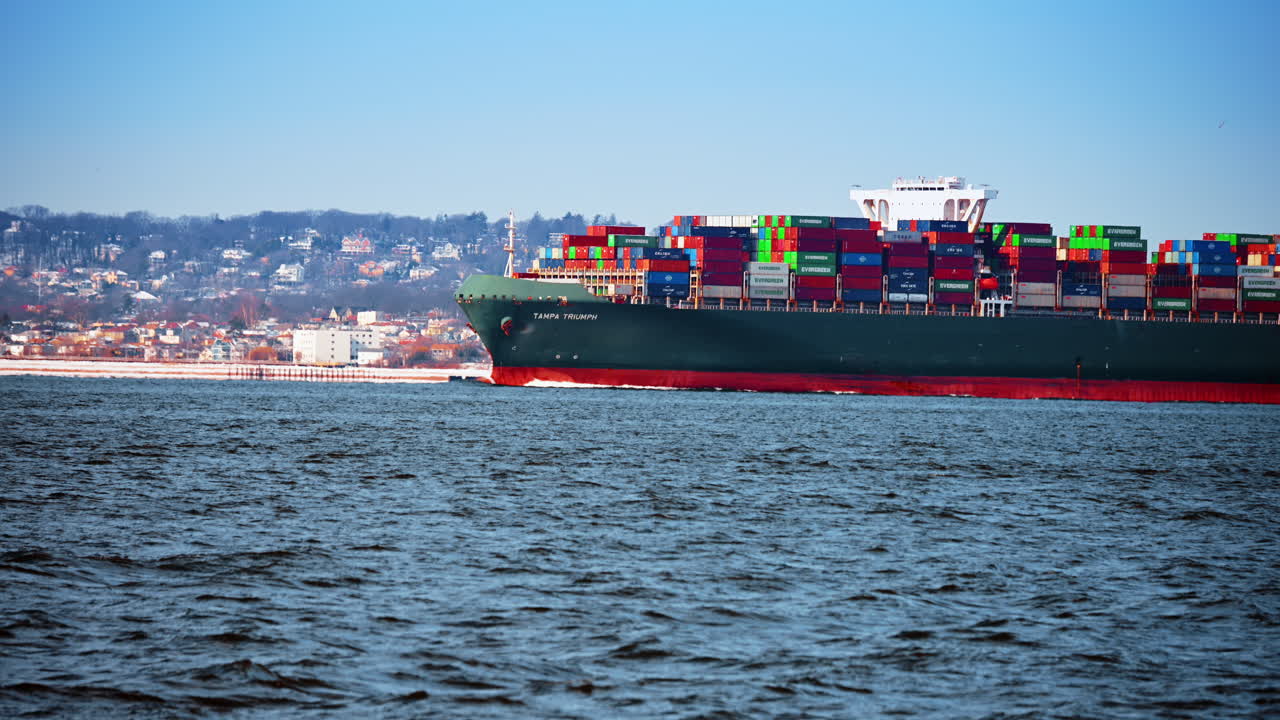 New York, USA, 28 December 2025: Cargo vessel crossing New York Harbor. Modern cargo vessel transporting containers across New York Harbor waters
