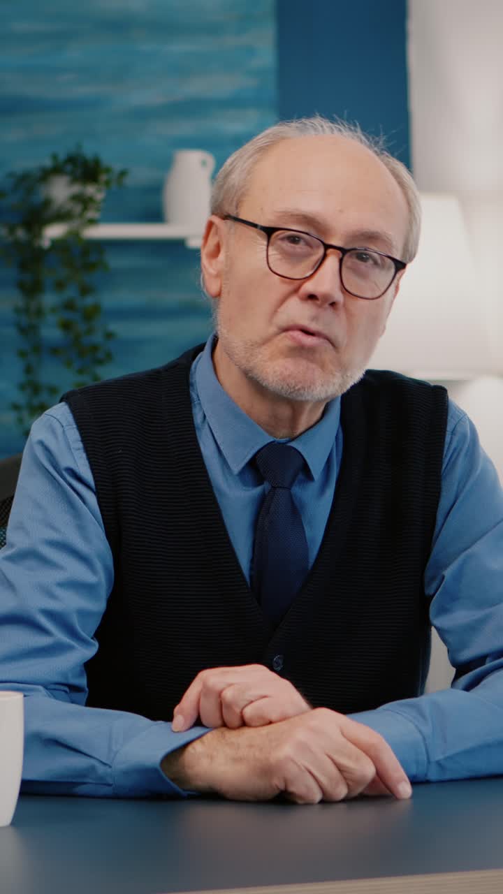Vertical video: Portrait of senior man chatting and listening remote teamwork
