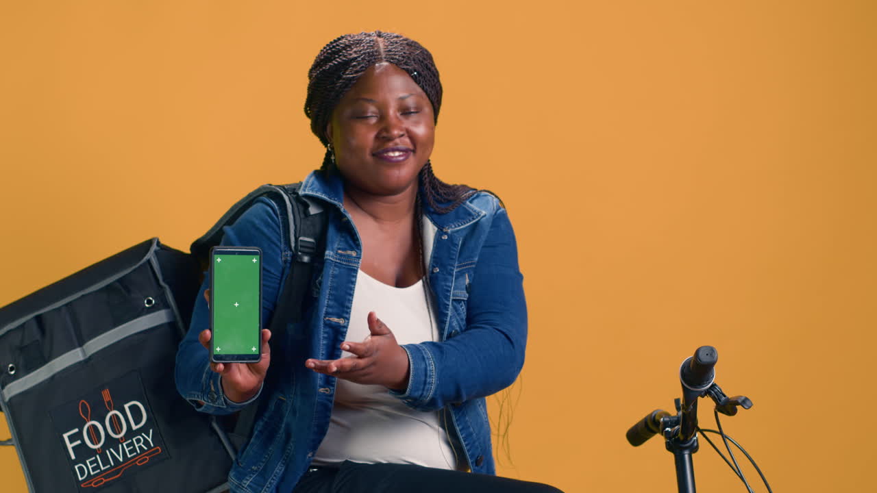 Female Holds Device With Green Screen