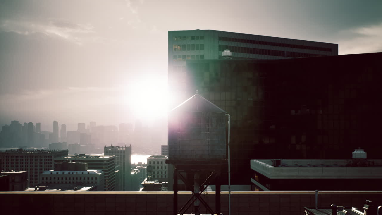 Sunrise over the city skyline showcasing water tower and urban buildings
