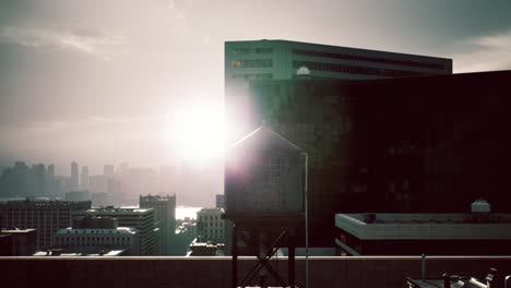 sunrise over the city skyline showcasing water tower and urban buildings