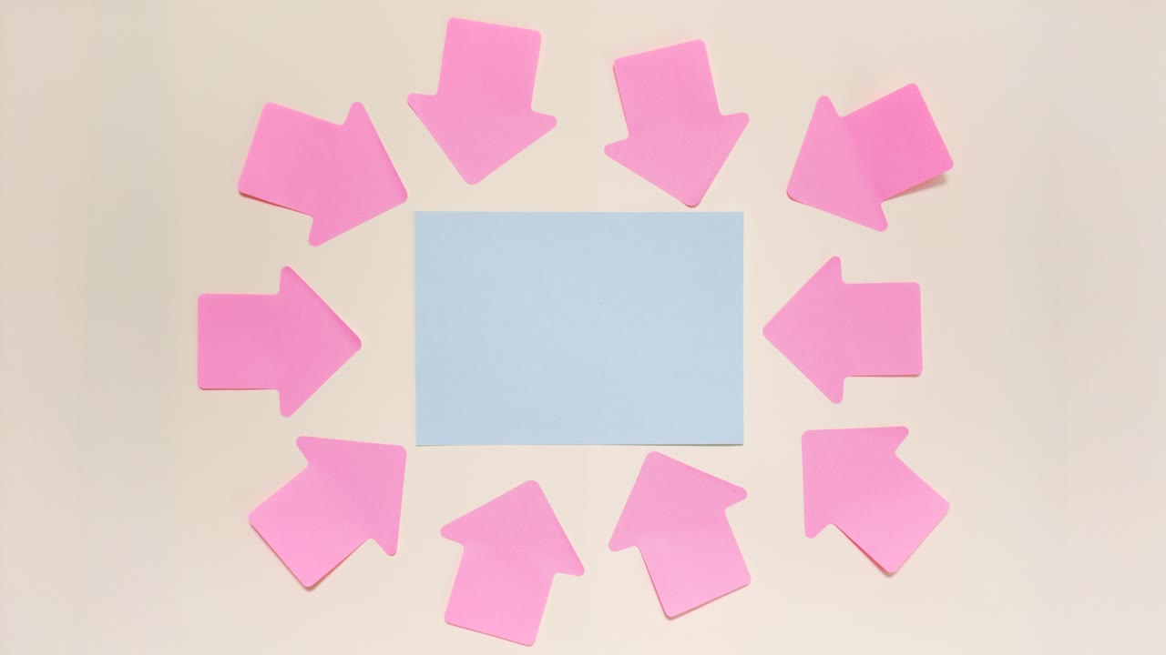 Stop motion pink sticky note arrows frame a blue card, leaving center copy space on a light background