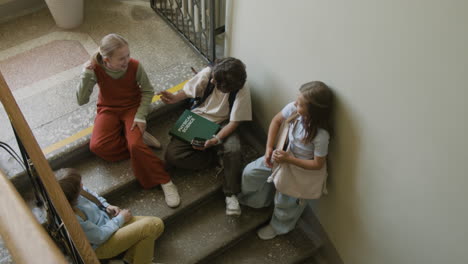 students chatting on a school staircase during a break