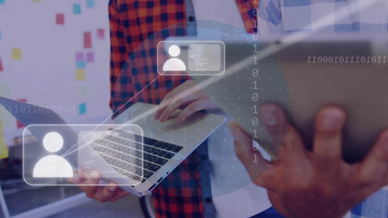 Two men using laptop pad and swiping tablet initiating tech overlays with user icons for sharing