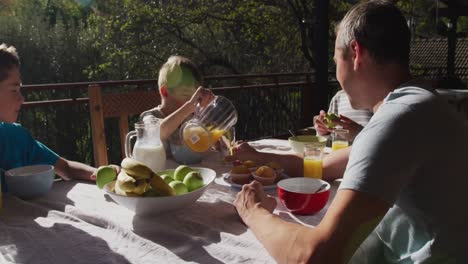 family eating breakfast together outdoors