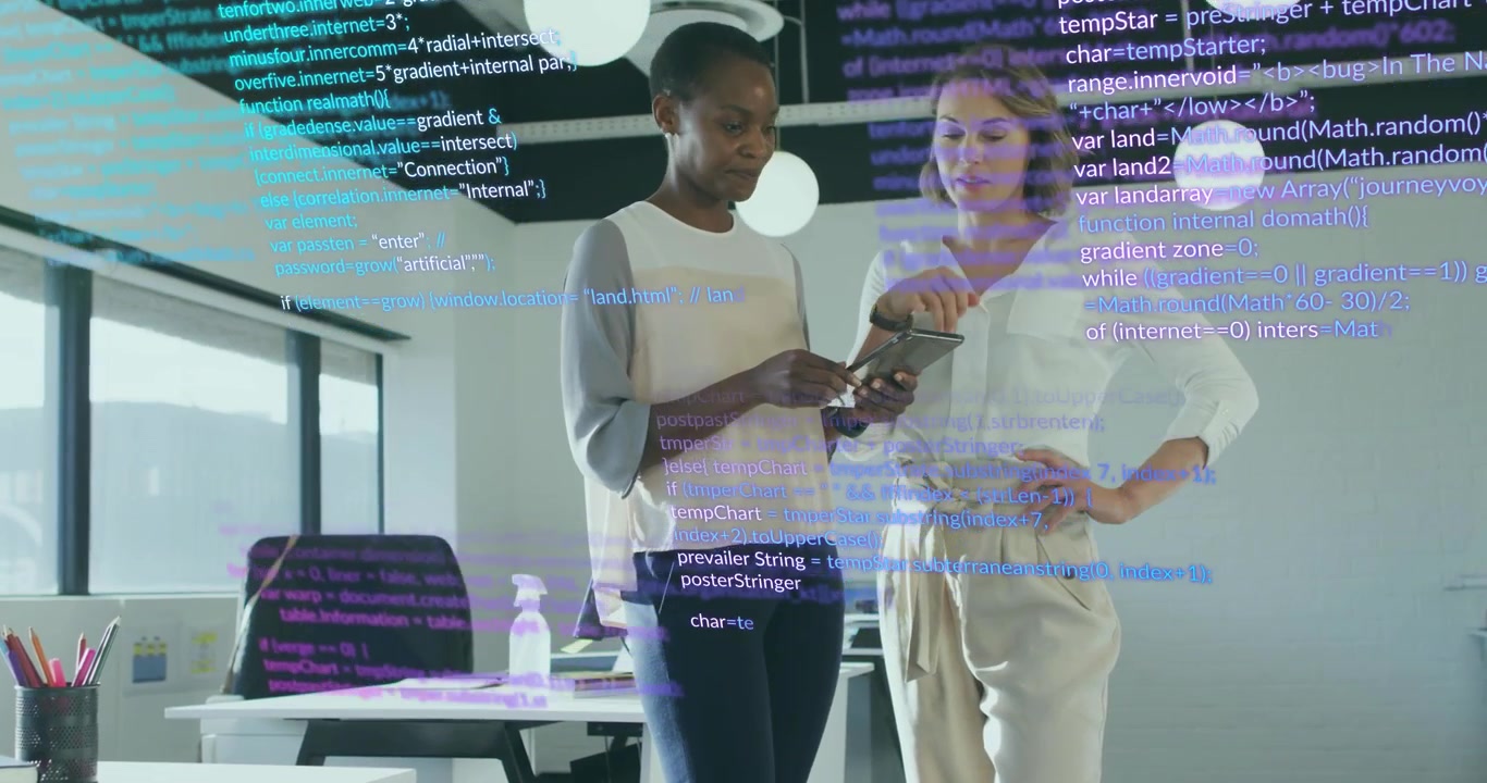 Two colleagues tapping tablet and navigating animated code overlay while reviewing software design