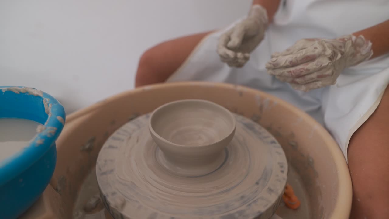 Close-up of hands working on a pottery wheel