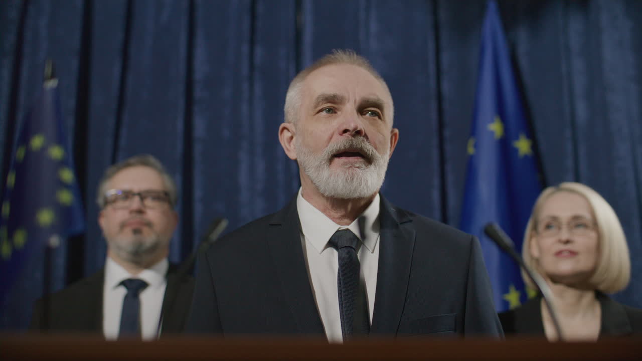 Senior Diplomat Delivering Public Speech at European Political Event