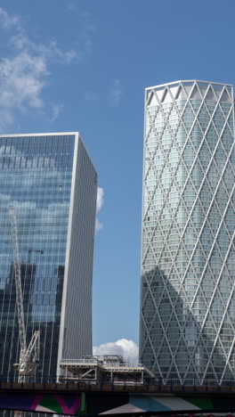 canary wharf in london, pov shot from the moving docklands light railway in vertical