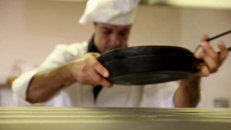 Handsome-chef-wiping-down-the-counter