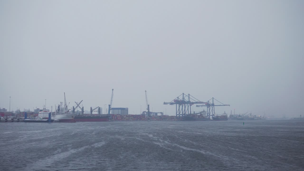 a shot from the ferry captured Curonian lagoon and the port of Klaipėda during the winter season