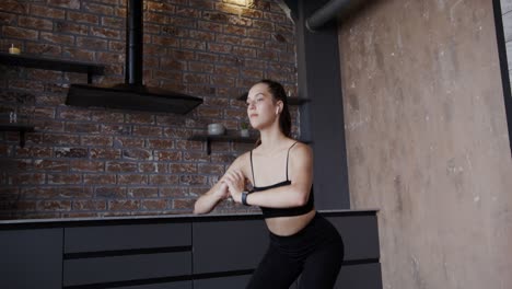 woman doing squats in her kitchen