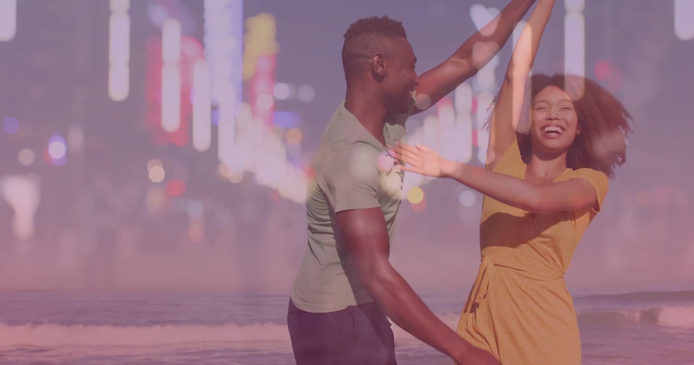 Uomo che prende la mano di una donna, guidando tuffi e piroette sulla spiaggia con una sovrapposizione di cuori bokeh per marketing.