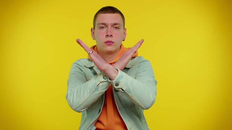 Man say no hold palm folded crossed hands in stop gesture, warning of finish, prohibited access