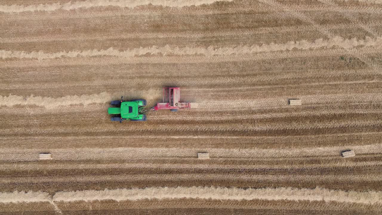 Hay collecting tractor harvest season rural village life agriculture field, aerial drone