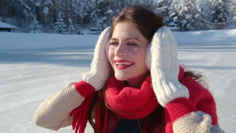 woman enjoying winter day on ice rink