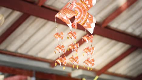 colorful fish mobile swaying under a roof