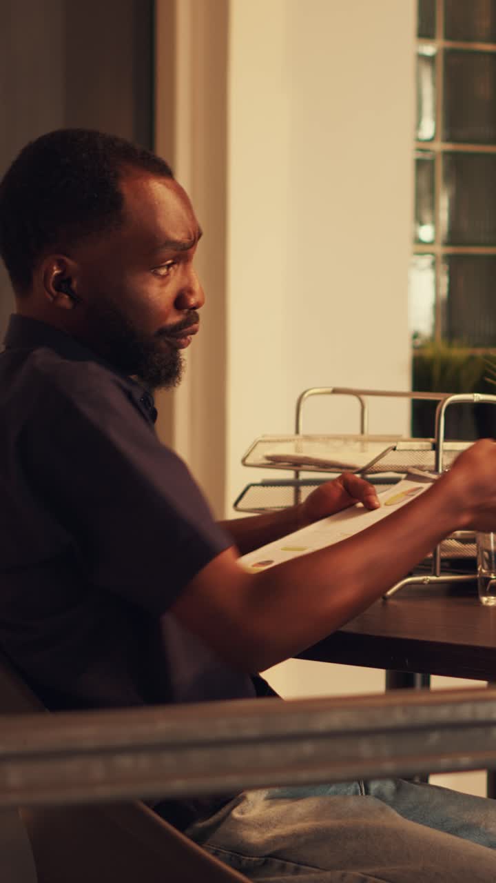 Vertical video: Male manager using remote teleconference call with colleagues