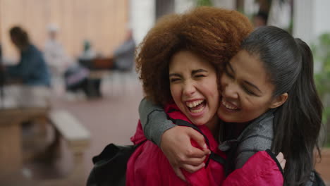 portrait of young woman suprise hugging kissing friend girlfriends laughing embracing enjoying togetherness urban youth friendship hang out