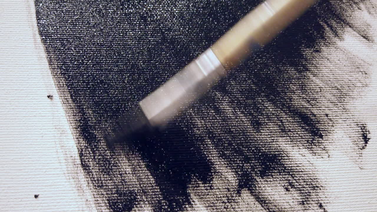 Close up of a woman paining on a paper at an art gallery workshop