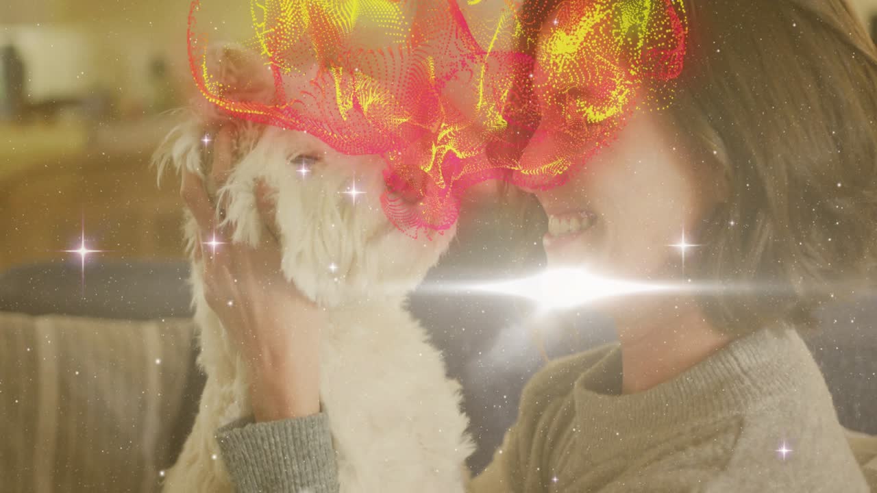 ソファで女性が犬を抱き上げ、鼻を寄せ合っている。顔には愛情あふれる輝きが広がり、ペットケアの様子がうかがえる。