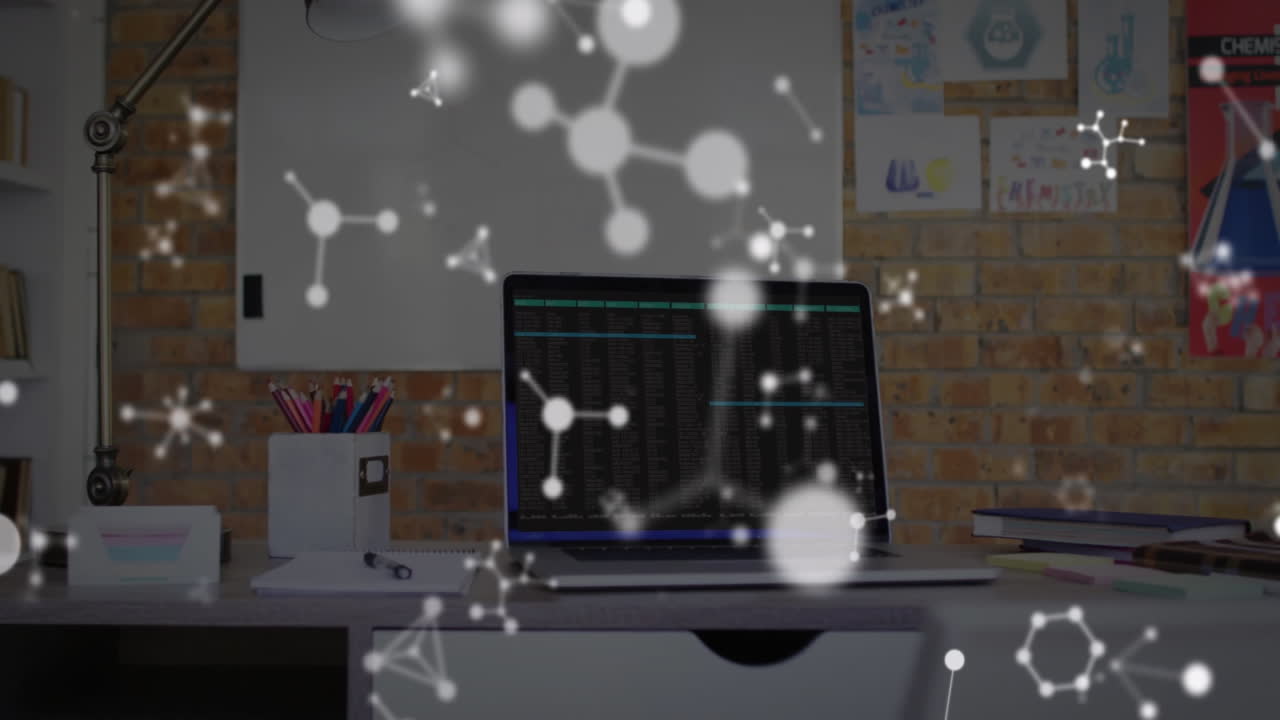 Creative workspace featuring laptop displaying code on desk, posters, molecular graphics overlaying