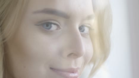 close-up of a woman with blonde hair and blue eyes