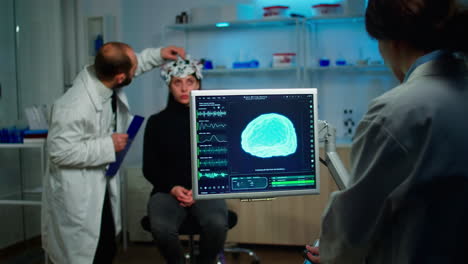 science doctor looking at computer with medical brain scan film