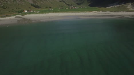 Drone shot of Hoddevik beach over the water. Opening-tilt up shot revealing Hoddevika beach in Sogn og Fjordane.