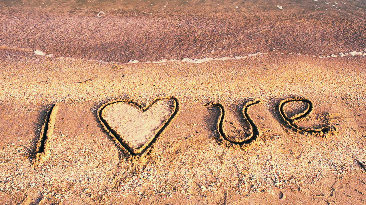 Inscription on sand. I love. Shooting on the beach